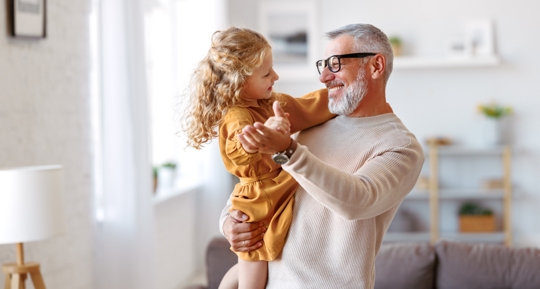 grandfather dancing with granddaughter