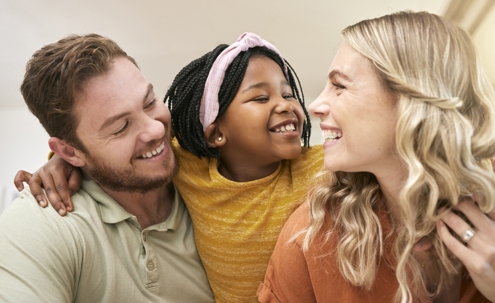 parents with adopted child laughing